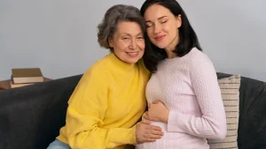 Same-sex female couple discussing reciprocal IVF and shared motherhood with a fertility specialist.